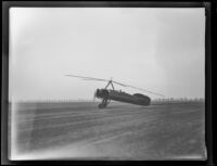 Autogiro, Missing Link, piloted by Johnny Miller sits on a field, Los Angeles vicinity, 1931