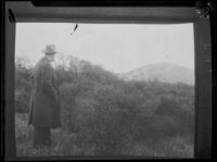 Man astanding in a hillside area photographed in relation to the investigation of the murder of Alberta Meadows by Clara Phillips, 1922