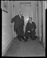 Mayor James Rolph and William S. Hart use their boot jacks, Los Angeles, 1926