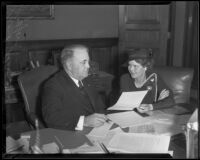 Mayor Frank L. Shaw and graphologist Muriel Stafford look over a document, Los Angeles, 1935