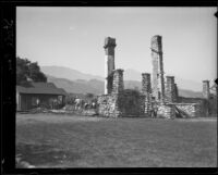 Stone remnants of William and Clara Steele's fire-destroyed home rise above the debris, Pomona, 1921