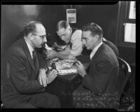 Norris Stensland looking over fingerprints with Lester Jones and R. V. Rogers, Los Angeles, 1931