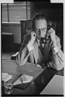 Judge Harry Sewell on the phone at his desk, Los Angeles, 1934