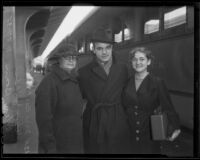 Gene Hibbs, USC football player, with his mother, Chlora and his fiancé, Helen Bonn, at a train station, Los Angeles, 1935