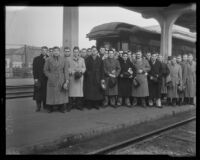 Trojans football team members arrive at a train station upon their return from the University of Notre Dame, Los Angeles, 1935