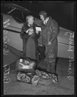 Frank Kurtz, aviator, and Betty Driscoll, USC student, next to his plane 