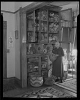 Mary Juanita Newland with her collection of Indian baskets at her Newland Ranch home, Huntington Beach, 1935