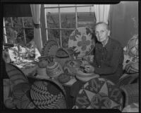 Mary Juanita Newland with her collection of Indian baskets at her Newland Ranch home, Huntington Beach, 1935