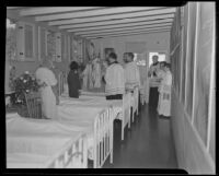 Bishop Cantwell providing confirmation at a tubercular rest home, La Puente, 1935