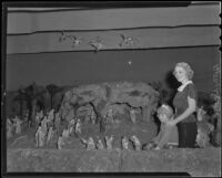 Betty Burke and a little girl beside a Nativity scene by Nino Ghio displayed on Olvera Street, Los Angeles, 1935
