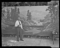 Jack Wilkinson Smith in front of a large landscape canvas at his studio, Alhambra, 1935