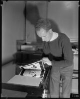 Photographer or technician manipulating photographs printed with images of Mickey Mouse, Los Angeles, 1935