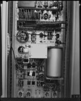 Bank of wires, a cylinder and an electric bulb, possibly part of a Wirephoto switchboard or power unit, Los Angeles, 1935