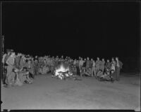 Boy Scouts grouped around a camp fire, circa 1935