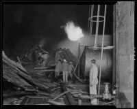 Three firefighters work to contain fire from an oil explosion at Petrol Corporation Refinery, Vernon, 1935