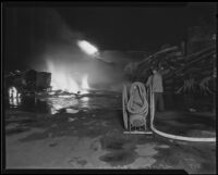 Firefighters hose down fire from oil explosion at the Petrol Corporation Refinery, Vernon, 1935