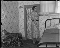 Donna Emptage standing in the backroom of a building previously rented by attempted kidnapper Leroy Anderson, Los Angeles, 1935