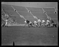 Football game between the UCLA Bruins and a Washington team at the Coliseum, Los Angeles