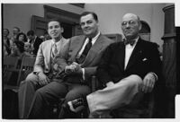 Three men seated in a courtroom during the embezzlement trial of Liberty A. Hill, Los Angeles, 1932