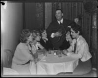 David L. Hutton, estranged husband of Aimee Semple McPherson, sings to a table of women in a nightclub, Los Angeles, 1933