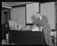 Asa Keyes, district attorney of Los Angeles County, with a suitcase and belongings, Los Angeles, 1923-1928