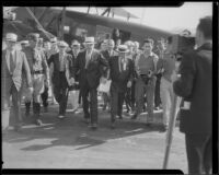 General Hugh Johnson, chief of the NRA, leaving an airplane followed by others, Los Angeles, 1933-1934