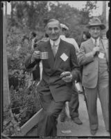 William G. McAdoo eating as strides down a pathway, 1920-1939