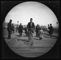 Thomas Allen on bicycle crossing the bridge from "Para," the Beyoglu district, to Istanbul, 1891