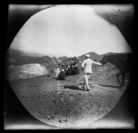 E.T. Platt with his horse passing a group of seated Iranians on a mountain road, Tabriz vicinity, 1891