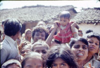 Gangadhar Nagar - village children with a baby greet the off-camera jeep of the researchers, Hubli (India), 1984