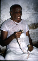 Tiruppati, leader of the Madurai Meenakshi Temple bhajan mandali, singing with kaimani cymbals, Madurai (India), 1984