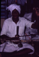 Agasta Lingam Pillai, leader of a Villupāttu (bow song) ensemble at the temple to Santhanamari, Kottaram (Tamil Nadu, India), 1984