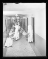 Medical staff and patients in corridor of Queen of Angels Hospital, Los Angeles, 1956