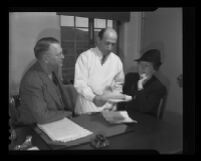 Doctor Jacob Frostig speaking with a man and woman, Camarillo State Hospital, Camarillo, 1940