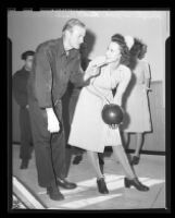 Pvt. Leroy Hood giving bowling instructions to Lt. Ruth Case at a recently built bowling alley in Birmingham Hospital, Van Nuys, 1945