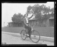 Ensign Dorothy Olson riding a bike, U.S. Naval Hospital, Long Beach, 1943
