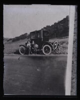 Clara Phillips and unidentified woman sitting against a car, Southern California, 1915-1922