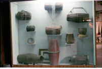 Museum display of nine membranophones (avanaddha) played with hands, Pune (?) (India), 1984