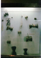 Museum display of twelve hourglass membranophones, Pune (?) (India), 1984