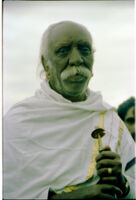 Kota man, K. Puchan, holding a koḷ double-reed instrument, Kollimalai (India), 1984
