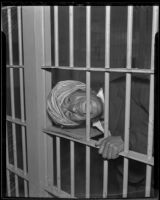 Prince Ucon pretends to bite the bars of his jail cell, Lincoln Heights, 1936