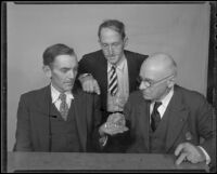 Three miners, Charles Boyd, John Herrod and Peter Flury, examine gold pieces, Los Angeles, 1936