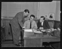 Assistant cashier E. J. Ryan, bus driver M. H. Fisher and bank manager Charles Griffiths review details of a robbery at Bank of America, Los Angeles, 1936