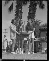 Margaret Brandel, Vernette Ripley and Joyce Hodgeman pose with a golf tournament trophy, Palm Springs, 1936