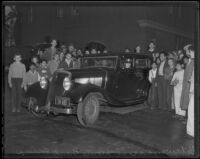 Spectators gather around the getaway car used in the robbery of Southern County Bank, El Monte, 1936