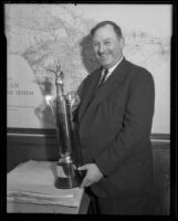 Supervisor John R. Quinn displays his shooting trophy, Los Angeles, 1936