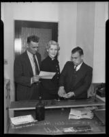 J. L. Nickell prepares Harriet Hunter for fingerprinting, Chief H. H. Mueller stands nearby, San Fernando, 1936