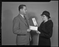 H. F. Thompson presents a check for $1000 to Mrs. Abbie J. Dutcher, Los Angeles, 1936