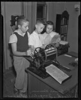 Bruce Kenson, Paul Bullock, and Jacqueline Williamson edit a newspaper for their school, Pasadena, 1936