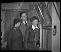 Aviators Blanche Noyes and Amelia Earhart and Earhart's husband George Palmer Putnam arriving after a cross-continental flight, Los Angeles, 1936